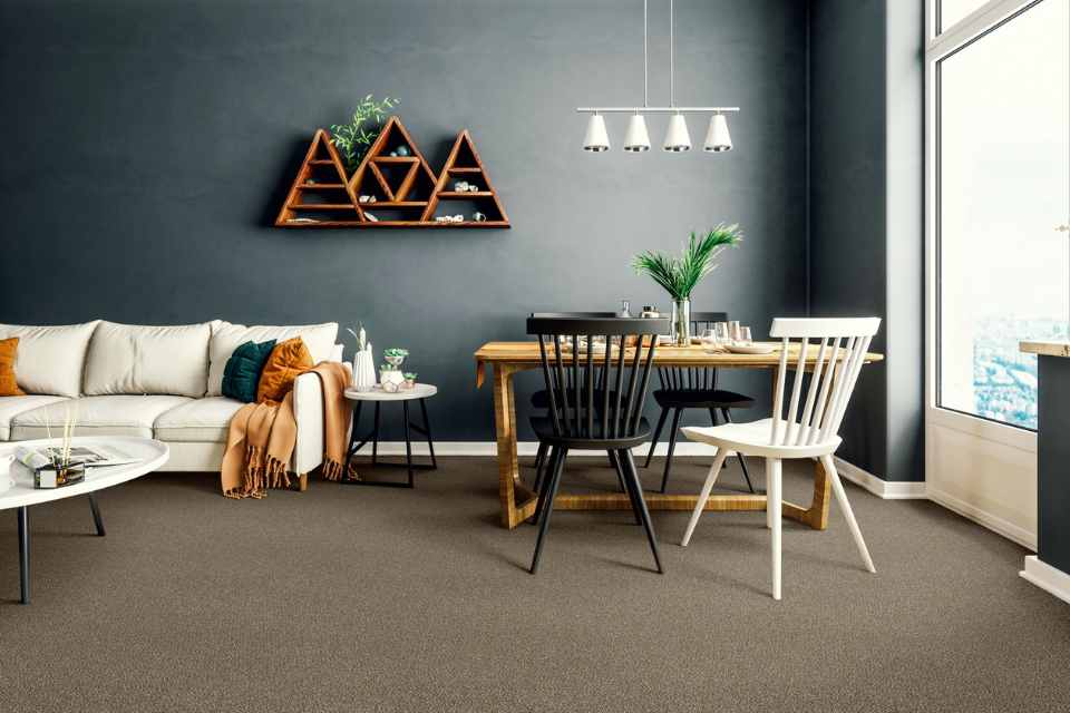 warm brown carpet in living room with gray accent wall and earth toned decor